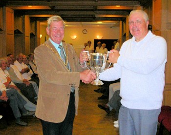 Mayor of Lichfield, Cllr Christopher Spruce hands the trophy to Bowling Club Chairman, Roland Cope