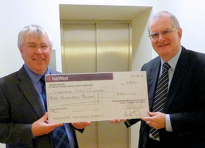 Alan Birch Clerk of the Swinfen Broun Trust (right) hands over the cheque to Lichfield City Council Clerk, Peter Young.