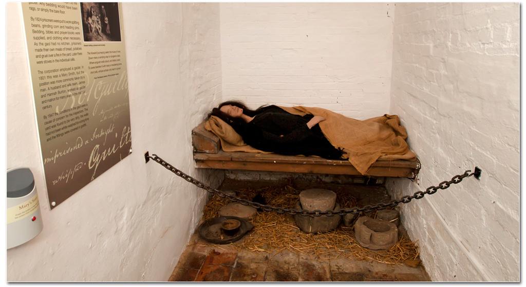 Woman in prison cell bed